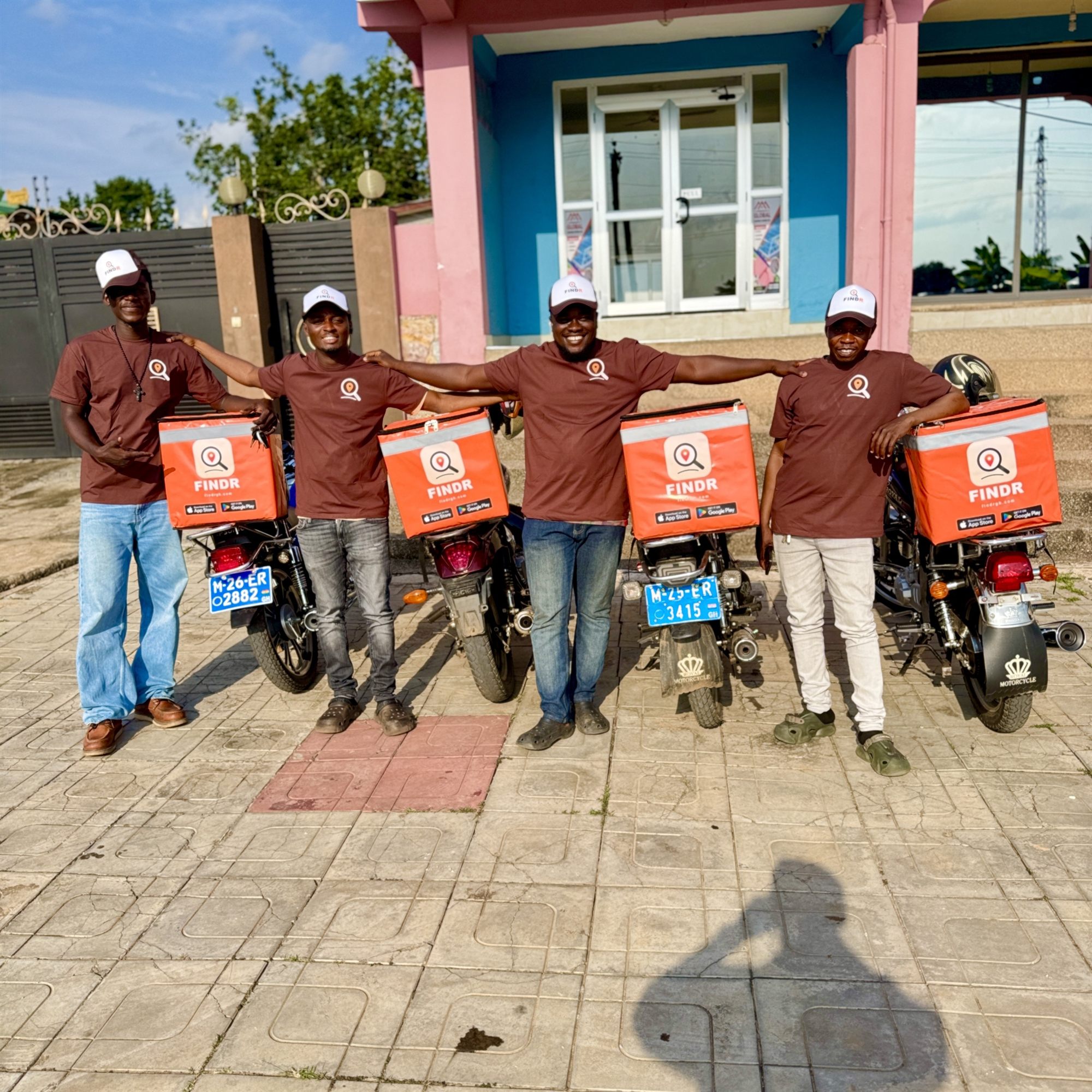 FINDR riders standing together in front of a local shop
